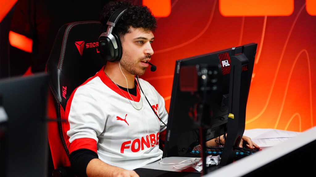 Esports player intensely focused on a game at a computer during a Counter-Strike event