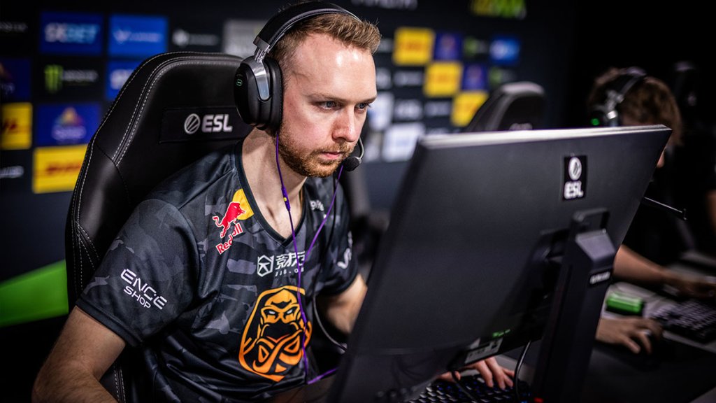 Esports player in team jersey focused on a Counter-Strike match at ESL event