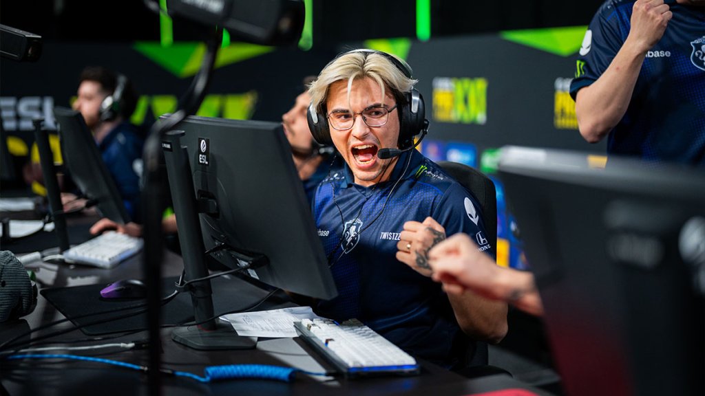 Excited esports player at a gaming tournament celebrating a victory