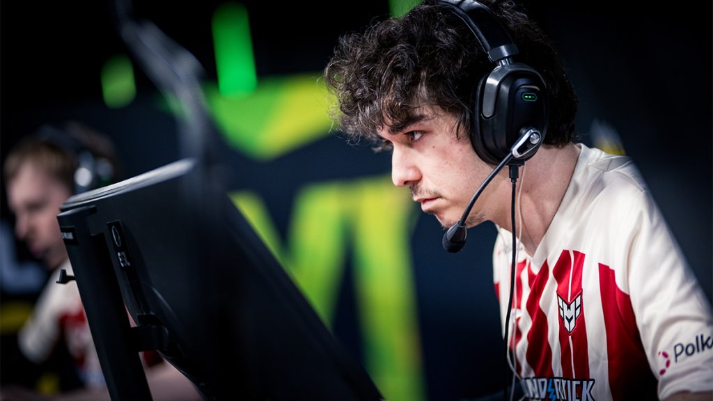 Focused esports player wearing a headset in an intense Counter-Strike match