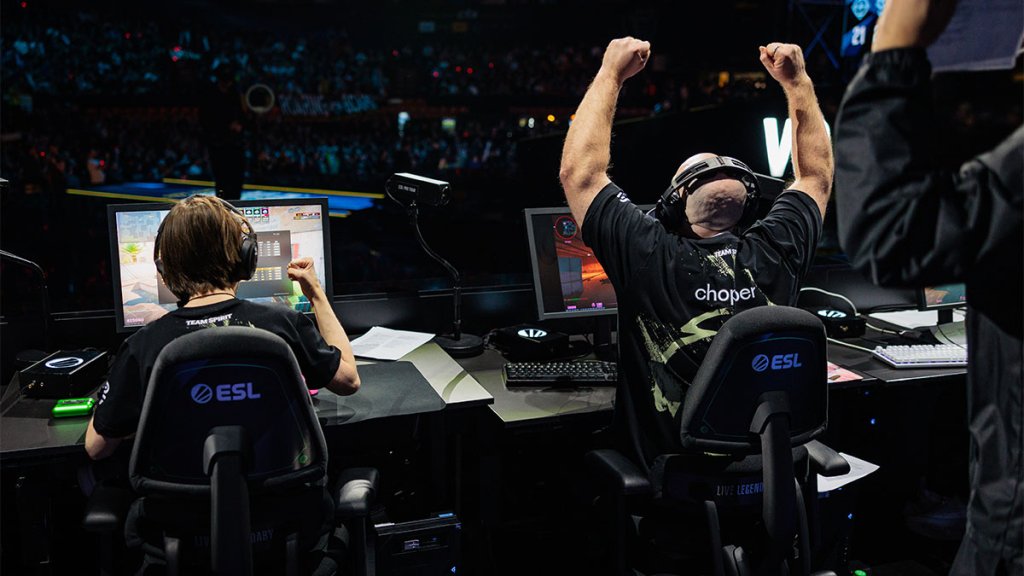 Excited esports players celebrating victory during Counter-Strike match at ESL tournament