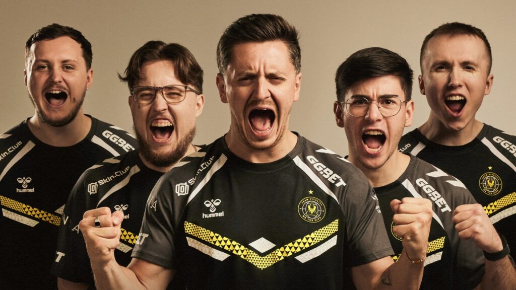 Excited esports team celebrating a victory in matching jerseys