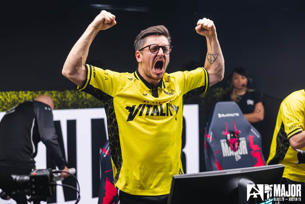 Esports player in Vitality jersey celebrates a Counter-Strike victory at a major tournament.