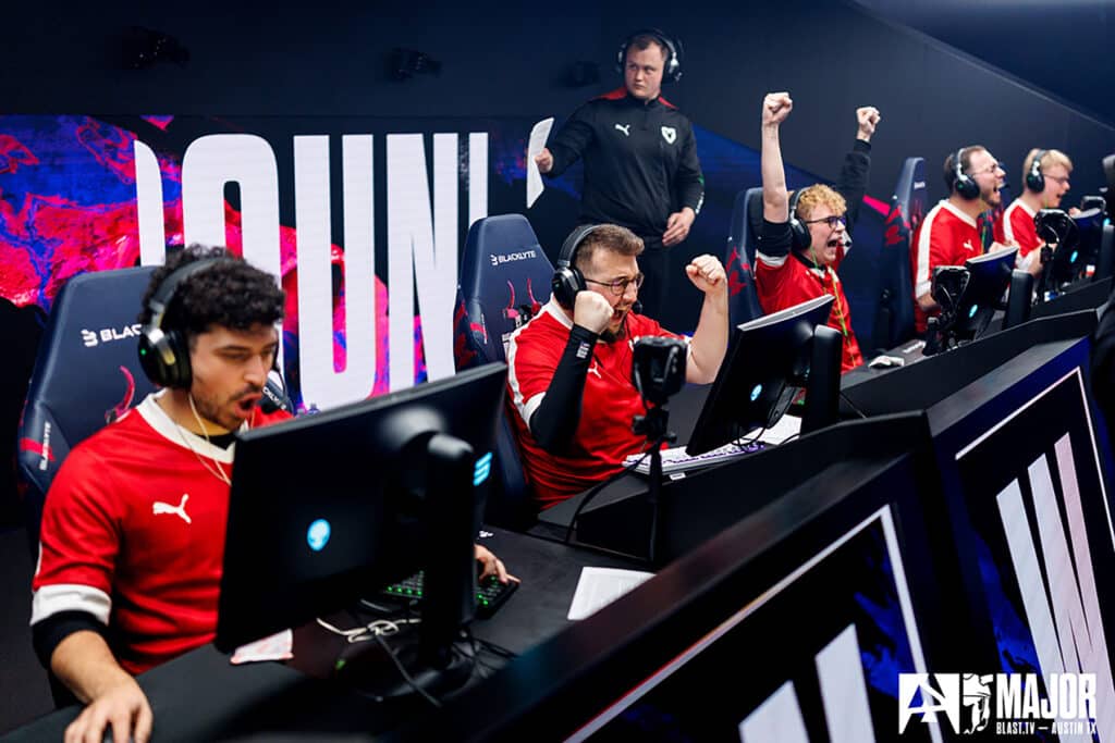 Esports team celebrating a win in a gaming arena at a Counter-Strike event