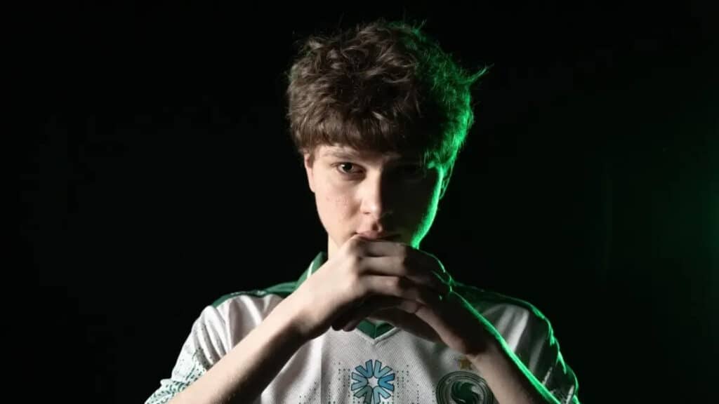 Focused Counter-Strike player in team jersey with green lighting