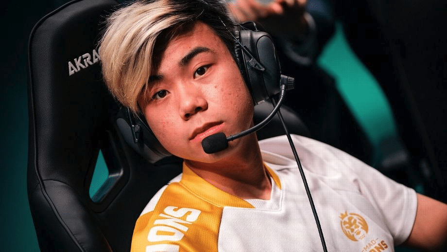 Esports gamer wearing headphones and a team jersey, focused during a gaming session.