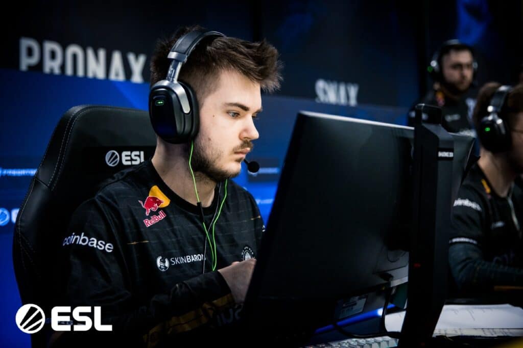 Focused esports player in headphones competing at an ESL event in Counter-Strike