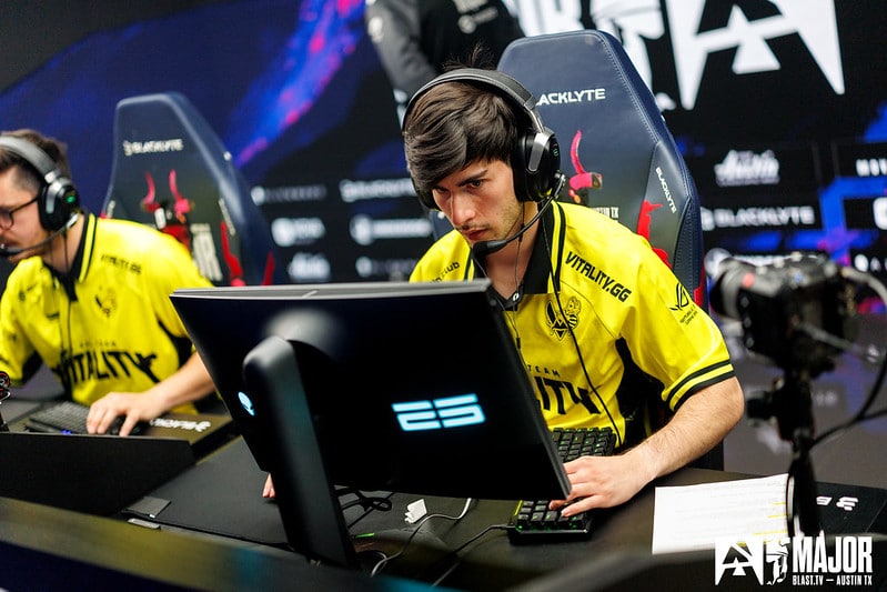 Esports players from Team Vitality focused intensely during a competitive Counter-Strike match at the BLAST Premier event.