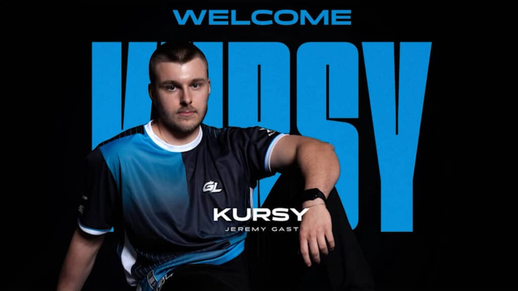 Counter-Strike esports player wearing a blue and black jersey with 'Welcome Kursy' text in the background