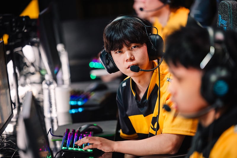 Esports participant focused on a gaming screen during an intense Counter-Strike match at a tournament