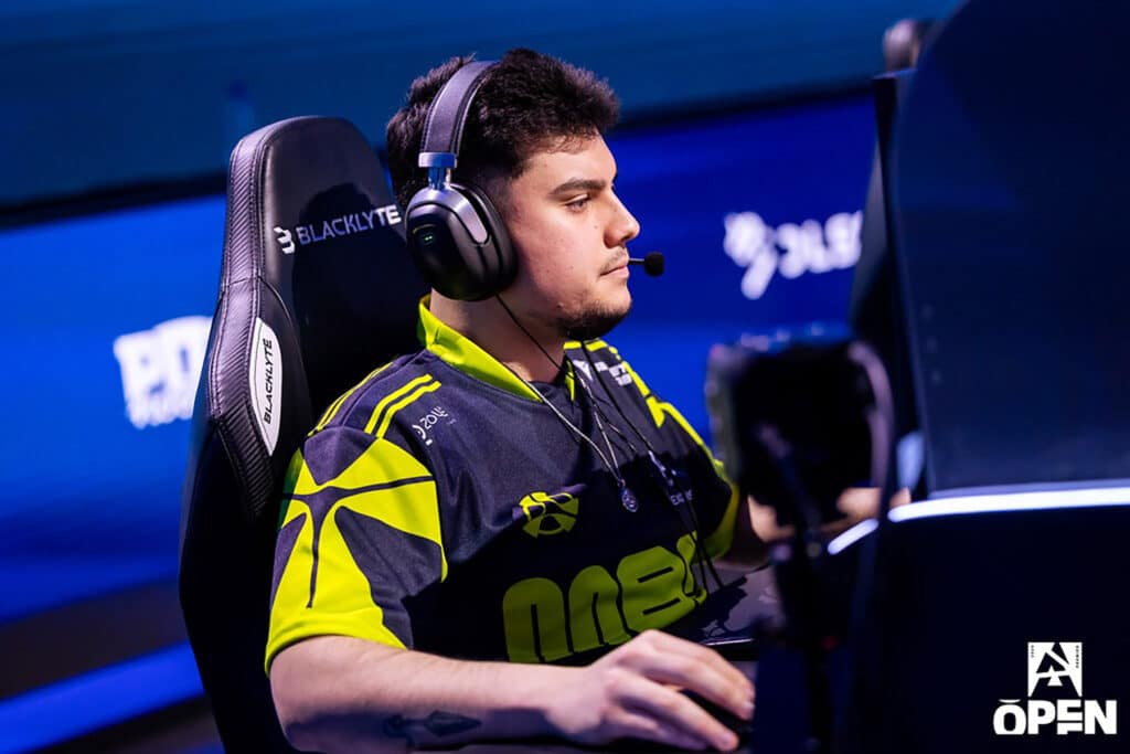 Esports player wearing a headset focused on a game at a tournament