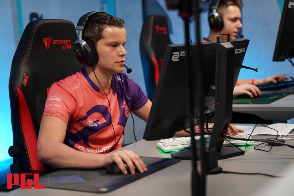 Esports players focused on a Counter-Strike match during a PGL tournament.